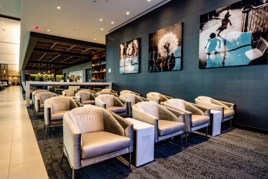 LuxShuttle private car service to Delta Sky Club Concourse B at Hartsfield-Jackson Atlanta — modern lounge with bar seating area