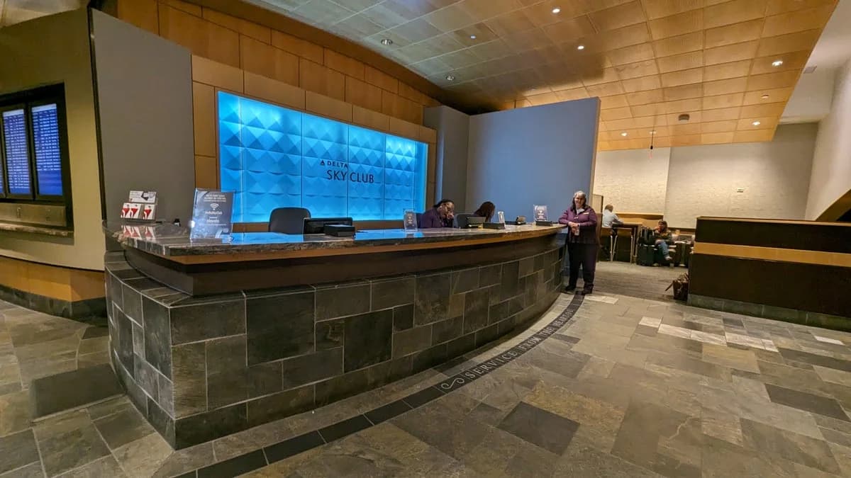LuxShuttle private car service to Delta Sky Club Concourse D at Hartsfield-Jackson Atlanta — grand reception desk and premium interiors