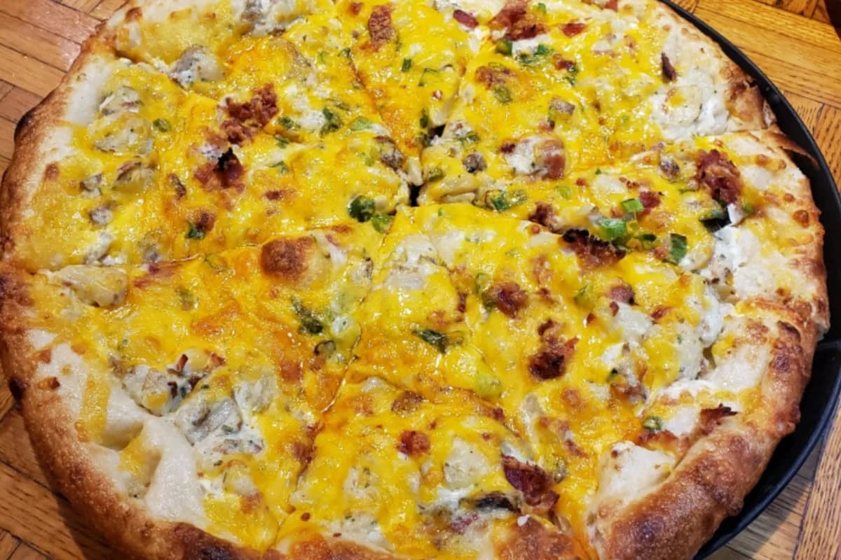 LuxShuttle private transfer to Partners II Pizza — hand-tossed Italian pizza in Peachtree City near Falcon Field