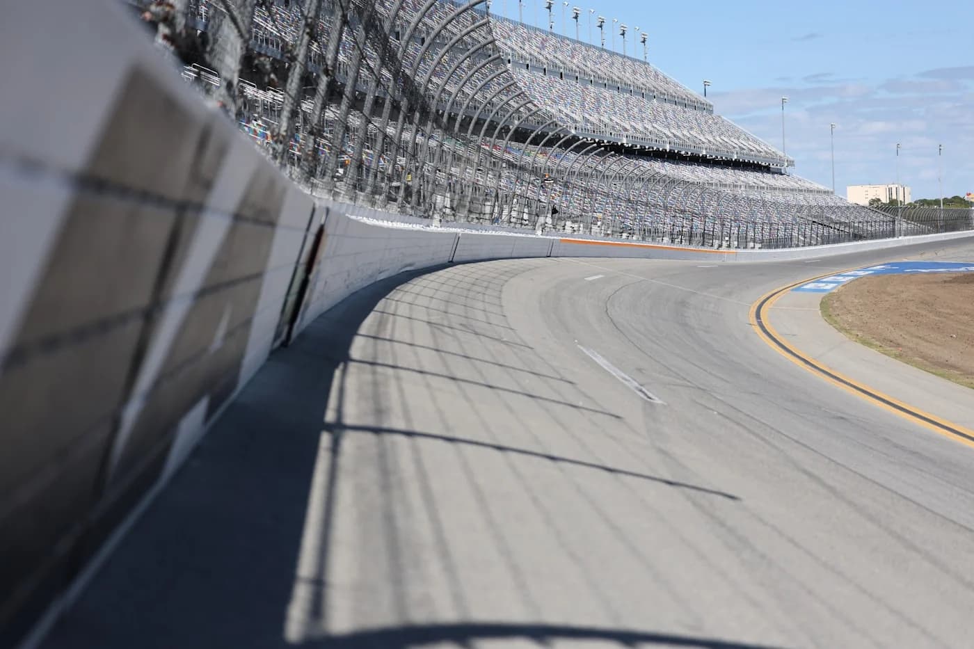 LuxShuttle private car service to EchoPark Speedway — racetrack grandstands and oval speedway