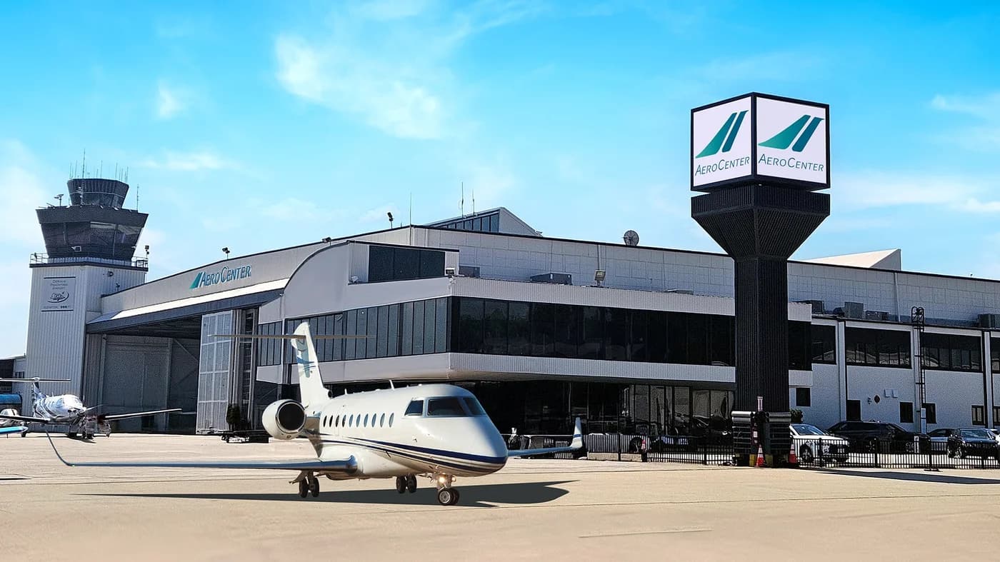 LuxShuttle luxury transfer to Aero Center Atlanta FBO at DeKalb-Peachtree Airport — private jet at modern terminal facility