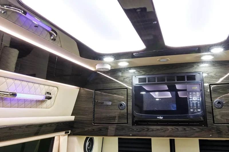 Interior of LuxShuttle Mercedes Sprinter with cream leather seating serving Atlanta metro areas