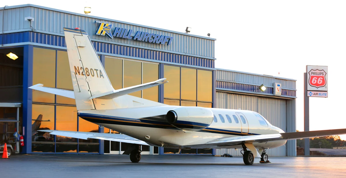 Private jets on the ramp at Fulton County Executive Airport Charlie Brown Field at twilight