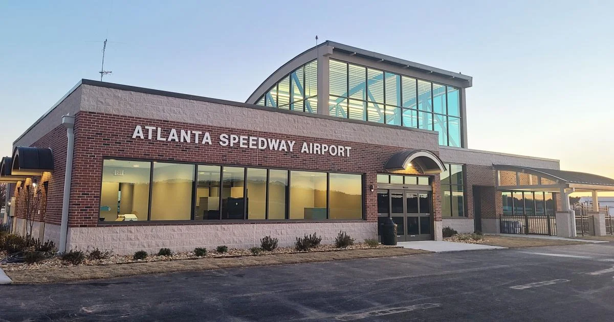 Atlanta Speedway Airport FBO terminal building with covered vehicle staging